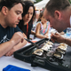 Judges carefully scrutinize a set of shucked oysters